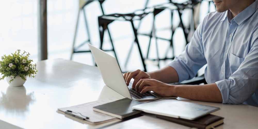 Smiling,Business,Man,Using,Laptop,At,Office.,Male,Hands,Typing
