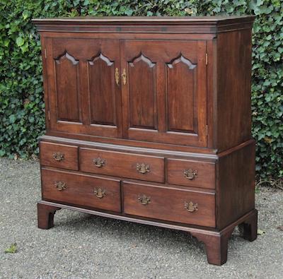vintage wooden cabinet with drawers and double doors outdoors
